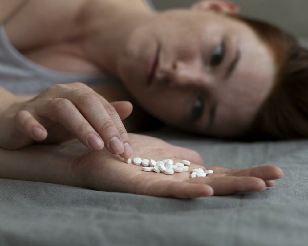 close-up-depressed-woman-holding-pills