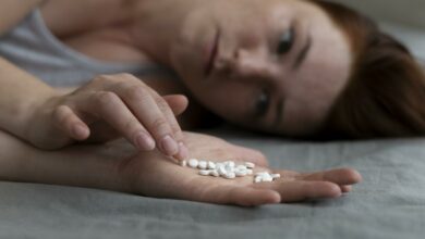 close-up-depressed-woman-holding-pills