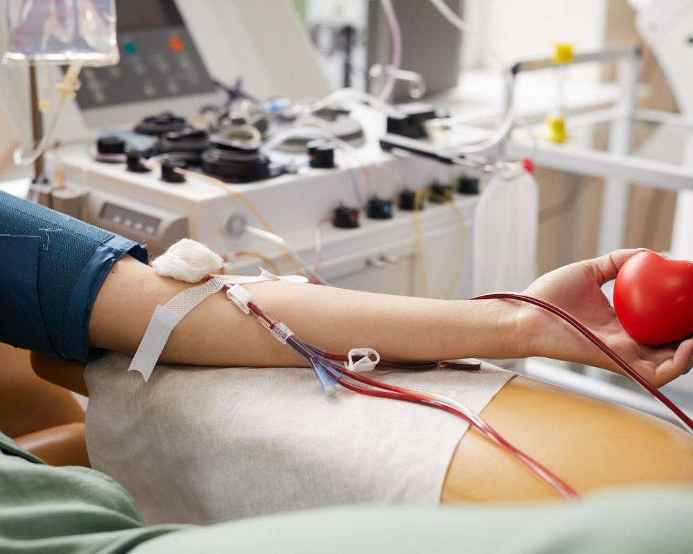 close-up-female-patient-with-tubes-her-arm-lying-couch-while-donating-blood-hospital