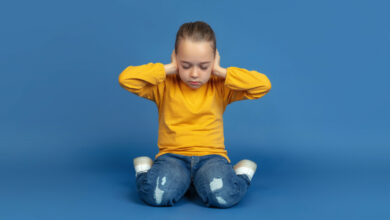 portrait-sad-little-girl-sitting-isolated-blue-studio-background-how-it-feels-be-autist-modern-problems-new-vision-social-issues-concept-autism-childhood-healthcare-medicine